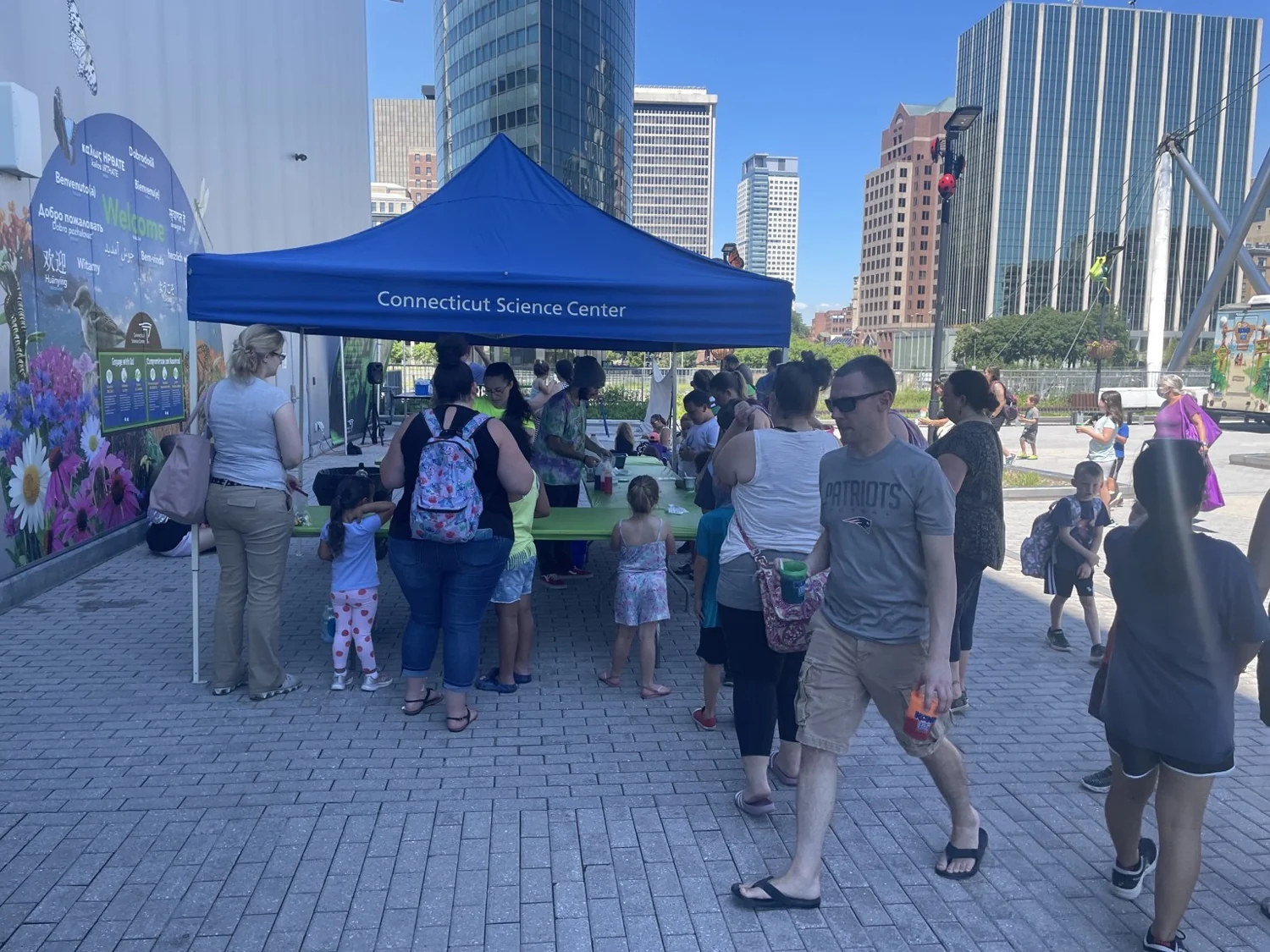 Families at an outdoor Connecticut Science Center activity booth